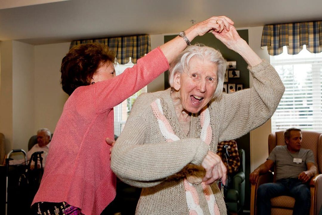 Clients dancing together at a day care event